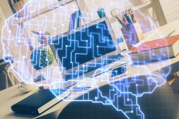 Double exposure of work space with computer and human brain drawing hologram. Brainstorm concept.