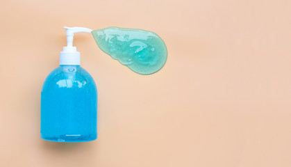 Alcohol hand sanitizer gel in pump bottle on old rose color background.