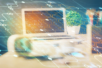 Double exposure of desktop computer and technology theme hologram. Concept of software development.