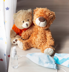 Soft toy teddy bear in a medical protective face mask. The concept of quarantine and self-isolation from the coronavirus virus and other diseases. Coronavirus time symbols.