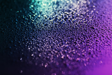 Close up of water drops on the black metal.