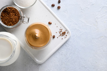 Dalgona frothy coffee on white. Trend korean drink latte espresso with foam of instant coffee. Top view. Created drink during Quarantine and self-isolation.