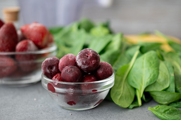 Frozen berries in a glass bowl with banana and spinach