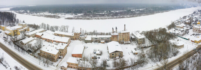 Panorama of the small town of Slobodskoy and industrial area near Kirov on a winter day from above. Russia from the drone.