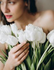 Obraz na płótnie Canvas European girl with white tulips