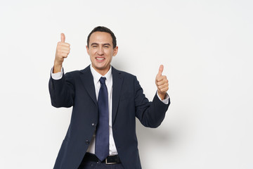 young businessman showing thumbs up