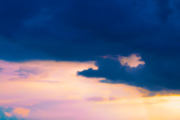 Dark stormy sky with the sun translucent