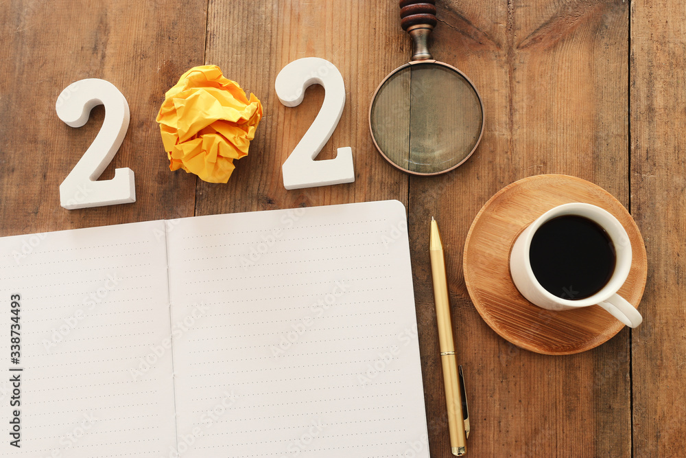 Fototapete top view image of open notebook with blank pages next to cup of coffee on wooden table. ready for ad