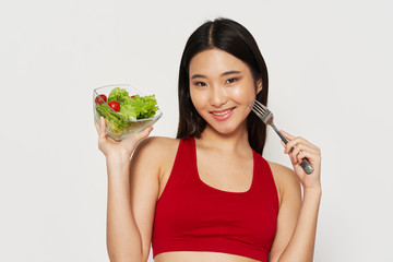 young woman eating salad