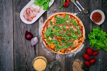 Styled Angle View of Large Ham and Rucola Pizza, Food Photography on wooden background table