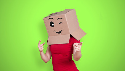 Person with cardboard box on its head and a happy face expression with a winking eye on green...
