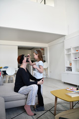 mother and daughter at home making facial mask beauty treatment