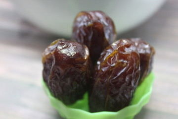 Sweet medjool dates with cup for ramadan kareem