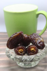 Sweet medjool dates with cup for ramadan kareem