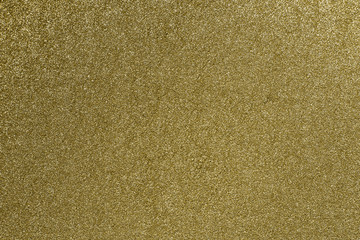 Fototapeta premium Detailed texture of glittering golden dust surface. Golden Shiny Wallpaper , Perfect for Christmas, New Year or any other Holidays Background. Golden fine powder