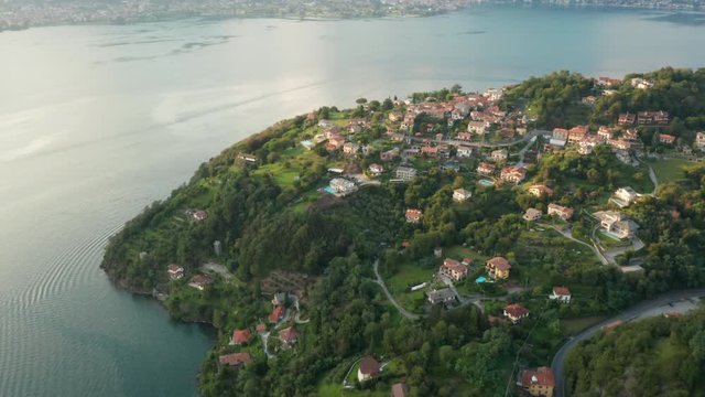 Fly over a small village with traditional colorful italian houses, Olgiasca, Italy
