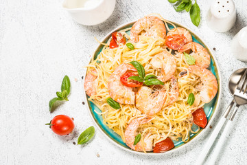 Pasta seafood with shrimp on white table.