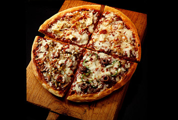 Pizza is divided into four pieces each square with a different flavor