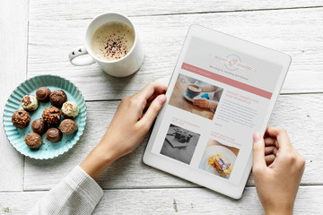 Aerial view of woman using digital tablet and snacks