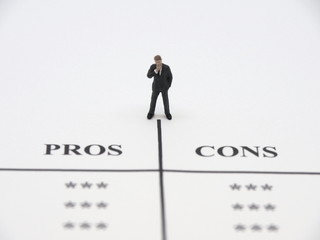 A miniature businessman thinking about pros and cons.