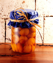 Jam is used in a glass jar with a cover of blue paper and a raffia lanyard
