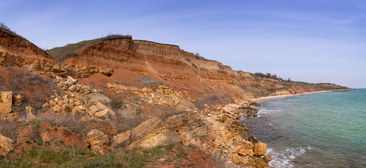Typical coastline of the northern part of the Black Sea coast with landslide processes. Shell rock cliff. Geological structure of the soil. Panoramic photo