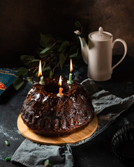 Chocolate cake with berries. bundt cake. Vegan cake. Birthday cake. Cake with candles. Piece of cake. Melted chocolate. Chocolate dessert. Birthday concept