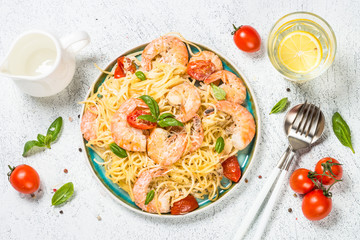 Pasta seafood with shrimp on white table.