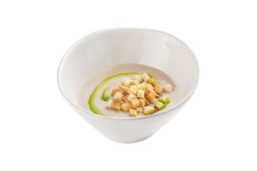 champignon mushroom cream soup in white bowl with bread croutons isolated on white background