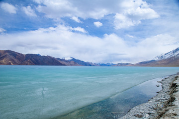 View landscape of Himalayas mountains and Frozen lake Pangong Tso high grassland lake while winter season for indian and tibetan and foreigner travelers travel visit at Leh Ladakh, India.