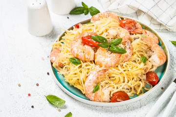 Pasta seafood with shrimp on white table.