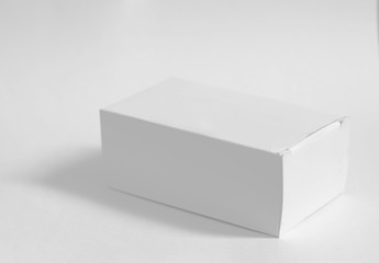 Closed white box on white background