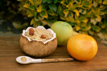 Two summer sour-sweet cups of lemonade with citrus lobules of lemons, oranges, grapefruits on the table under sunshine