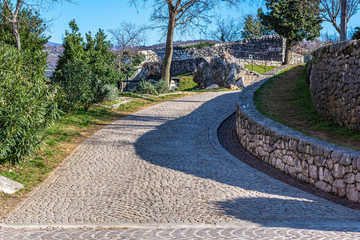 Close up view of cobblestone road leading from Trsat castle to green forest. Rijeka, Croatia,Europe.