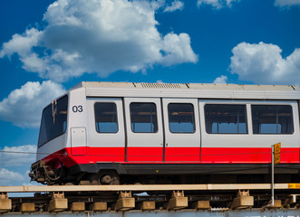 Fototapeta premium Red and silver mass transit train under blue sky