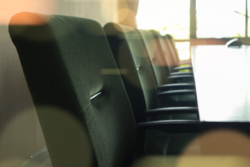 Row of green chairs in the conference room.