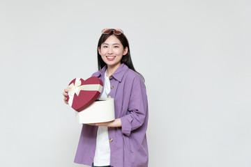 Fototapeta premium A young asian woman with a gift box in her hand