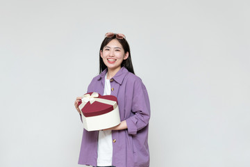 Fototapeta premium A young asian woman with a gift box in her hand