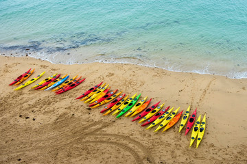 colorful summer beach with many kayaks on the sand at low tide in Saint Malo, France