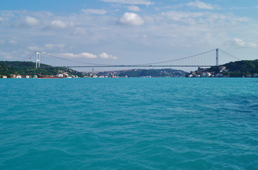 Turquoise Marmara Sea and the Fatih Sultan Mehmet Bridge in Istanbul on a cloudy day.