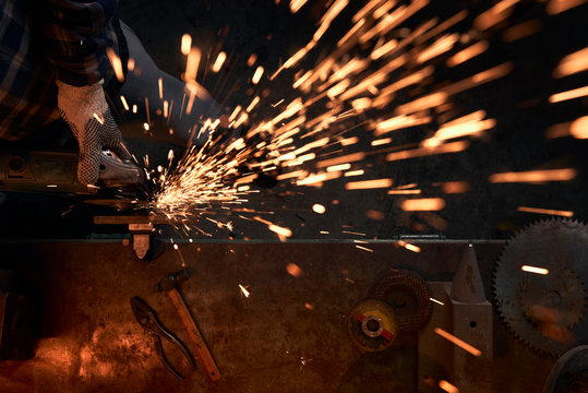 Sparks while grinding iron.worker grinding metal