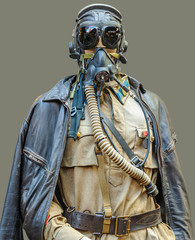 A mannequin dressed in military uniform with leather flying helmet, goggles, and oxygen mask, on...