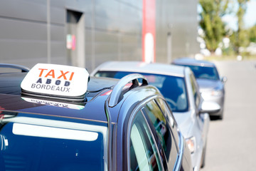 Taxi car parked in Bordeaux city with blurred background in selective focus France