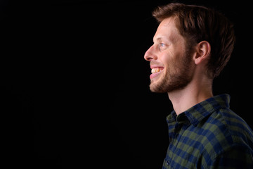 Closeup profile view of happy bearded hipster man smiling