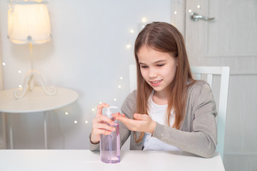 girl uses disinfectant to clean their hands.