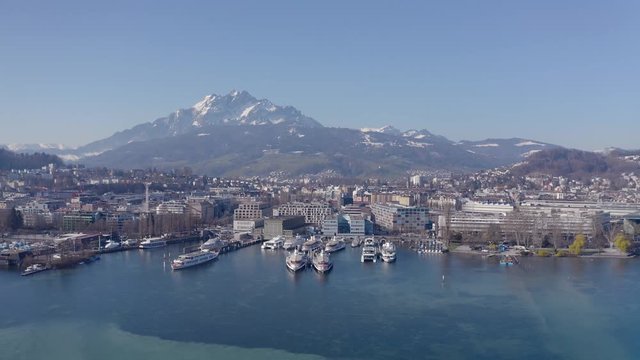 Drone flight over Lake Lucerne towards a swissmountain