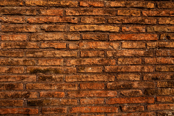 Aged red brick wall texture with sunlight