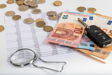 Financial statement with coins and banknotes. Finance and car key, saving money for a car or material design concepts.