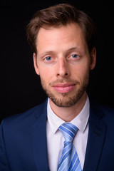 Face of handsome bearded businessman in suit