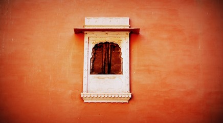 An Old Antique Window in Orange Wall